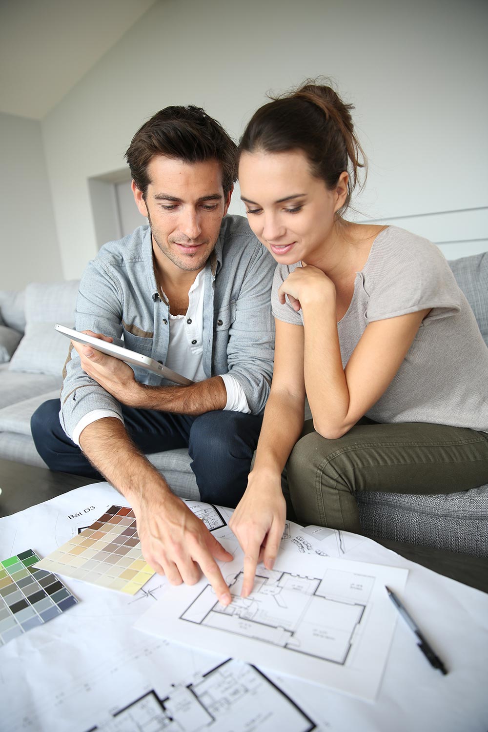 Couple Looking At Construction Plans Couple Looking At Construction Plans